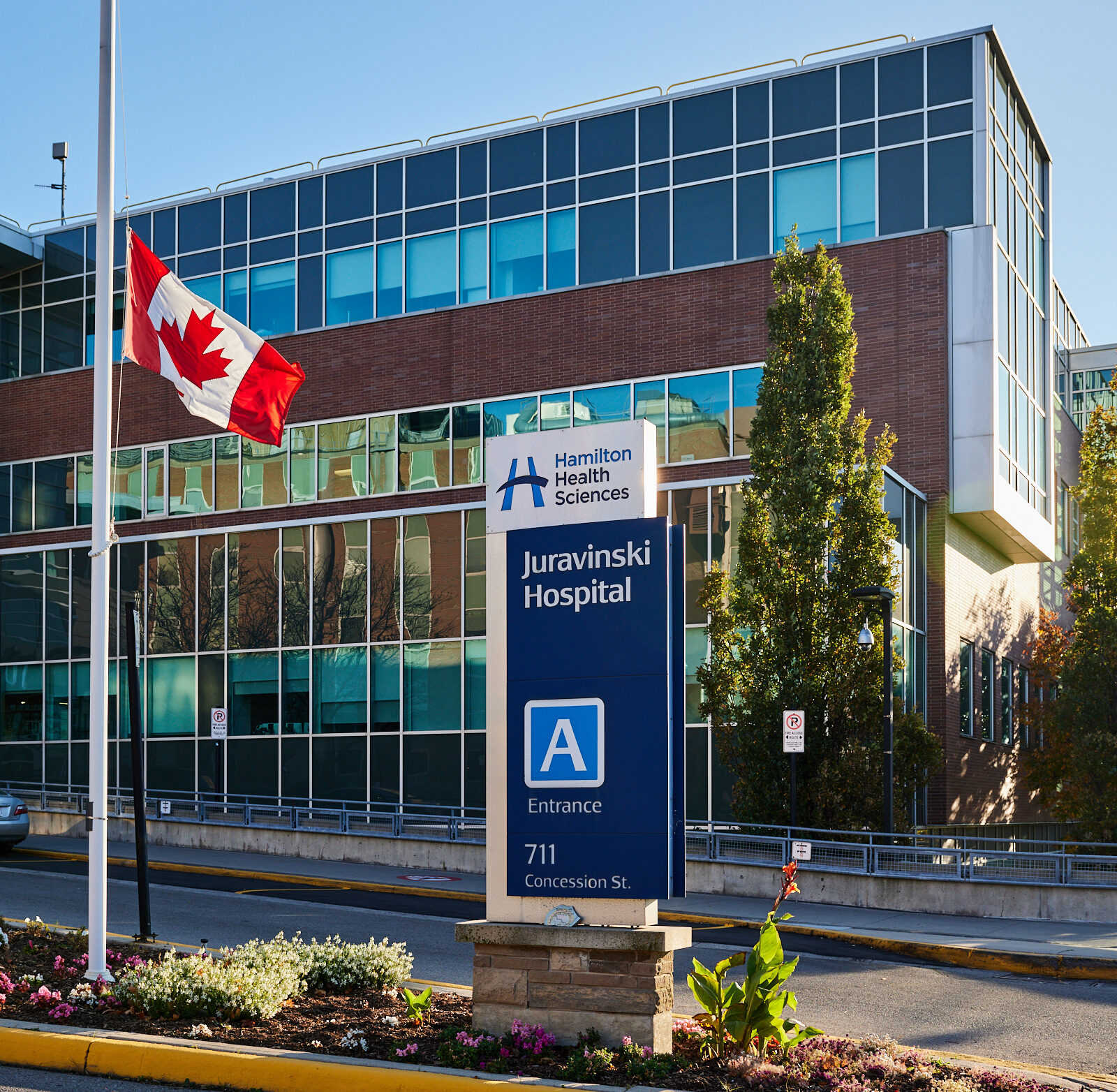 Juravinski Hospital building entrance with a Canadian flag.