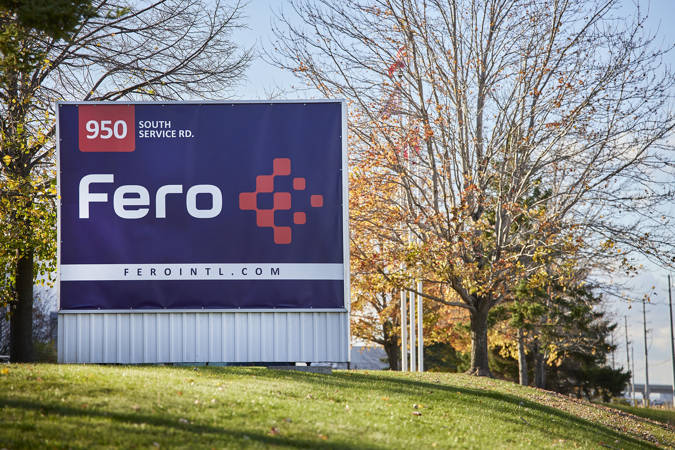 Exterior Fero International sign. Blue background, white and red logo.