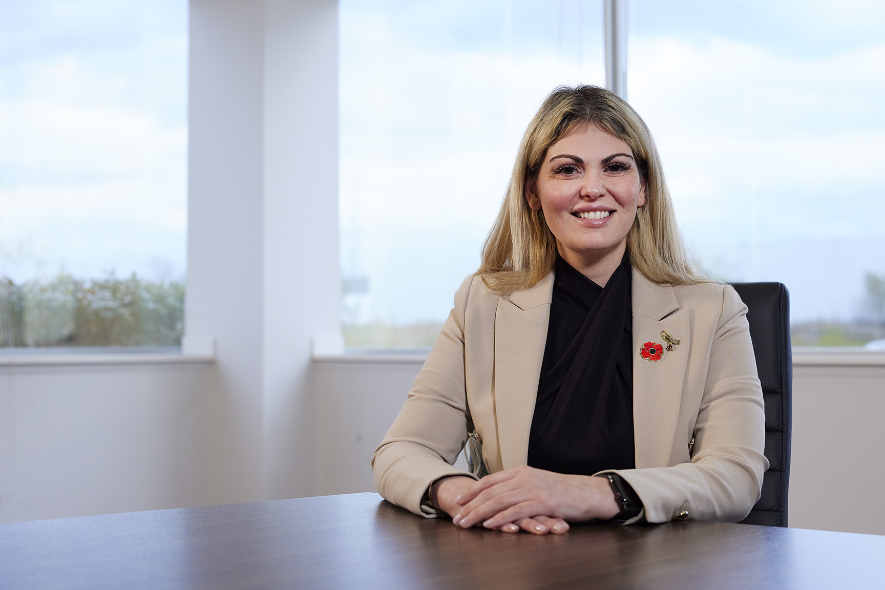 Sabrina Fiorellino - Blonde woman smiling at boardroom table.